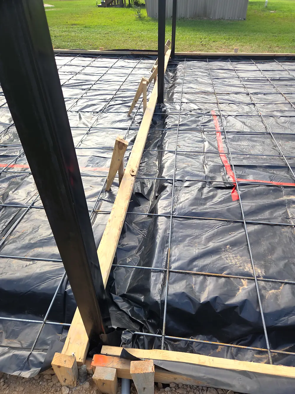 Vapor barrier and rebar tied inside wood forms